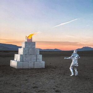 Pateka album cover with thermo-suited person standing in front of foreign object.