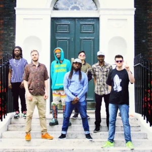 All seven members of Ghost-Note lined up on a stairway entrance